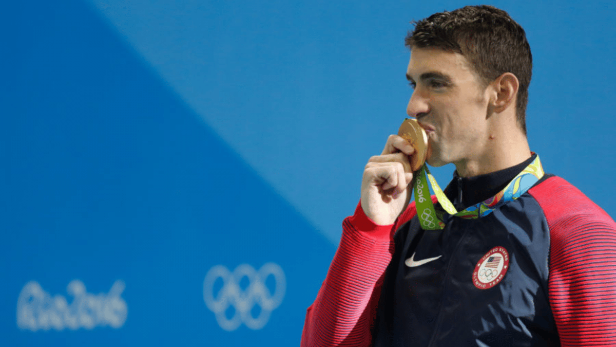 A picture of Olympic Icon Michael Phelps clutching his Gold Medal at a previous Olympics game.