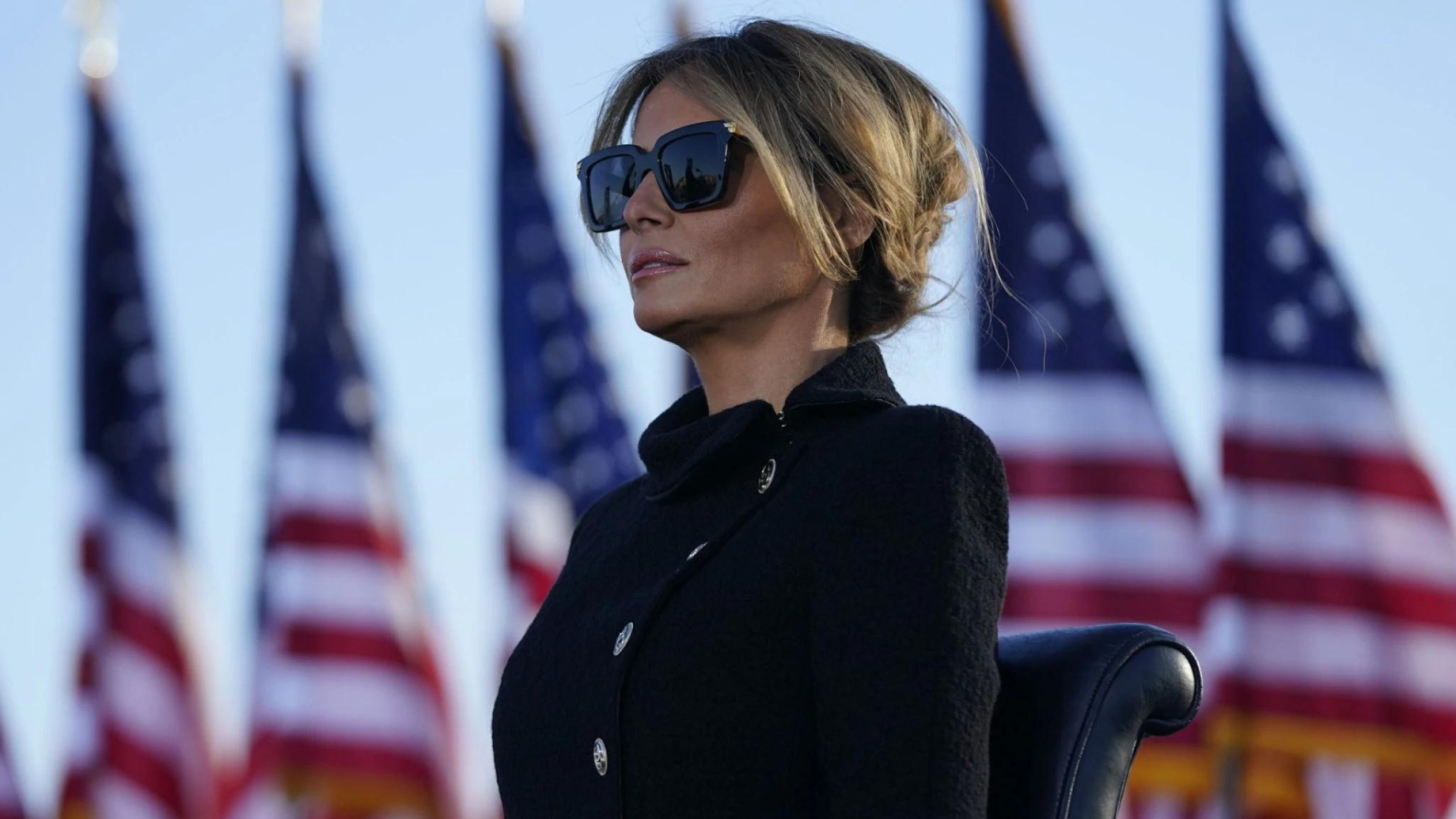 Trump NFT comeback: Melania Releases Collection A Picture of Melania Trump, who recently launched a new NFT collection, standing in front of a row of american flags