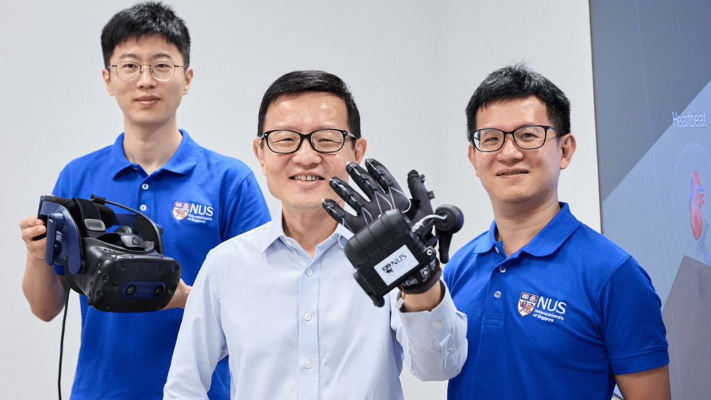 University Of Singapore VR Glove Will Let You Feel the Metaverse Three men stand before a white background in support of The University of Singapore VR Glove.