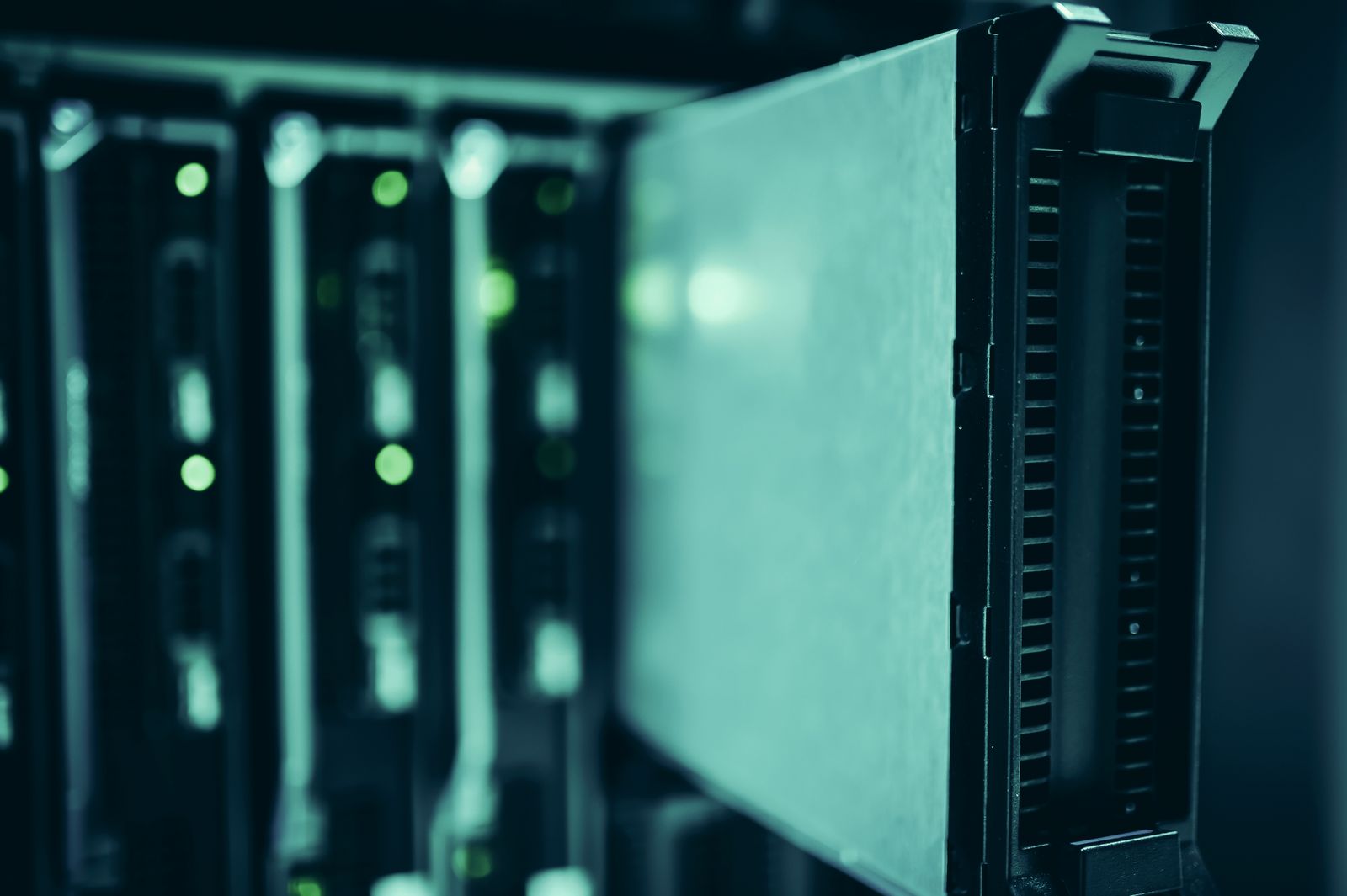 Rack-mounted servers with green status lights in a data center